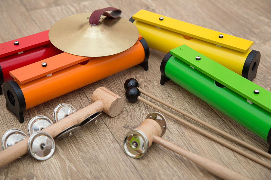 Multicolored classroom instruments on a wood table